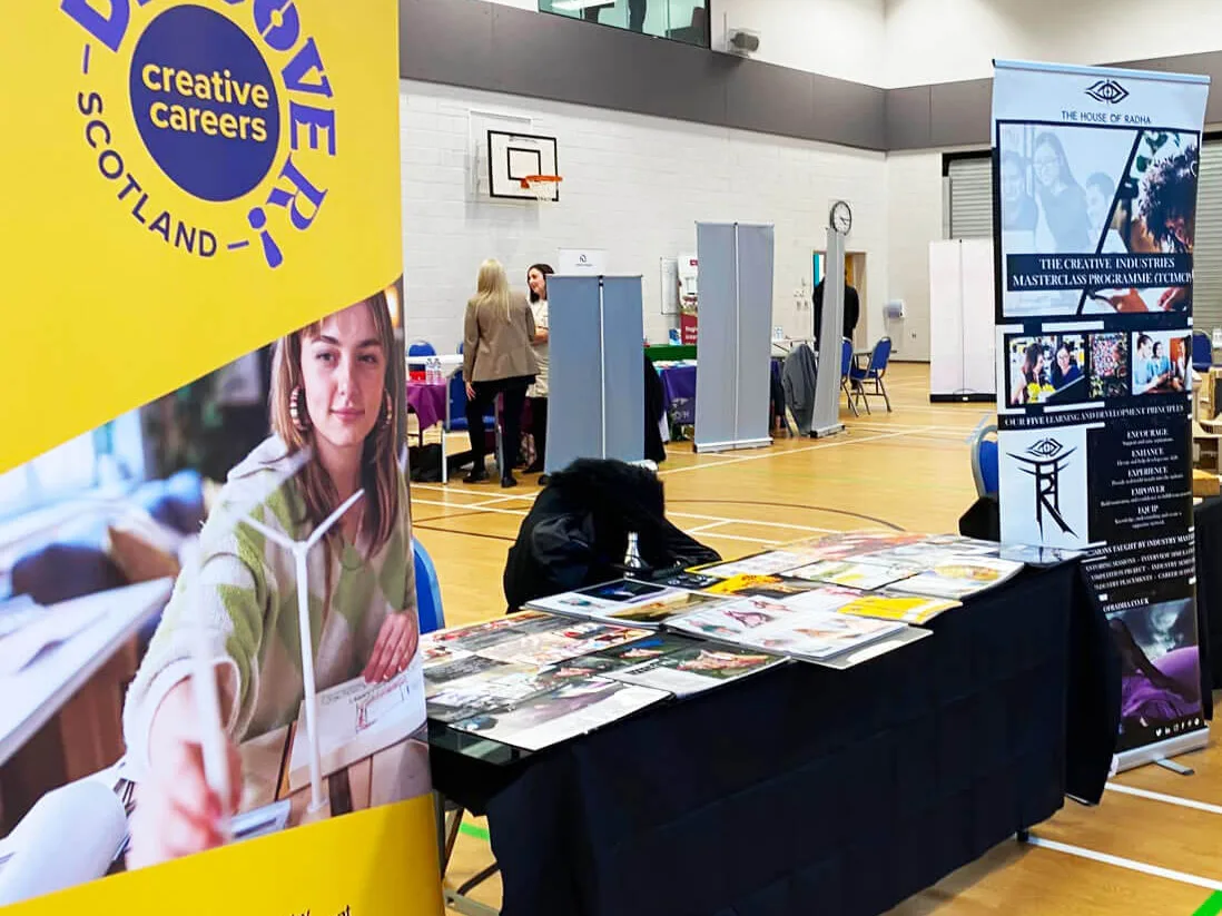 Discover Creative Careers Scotland exhibition stand at a career fair in a gym