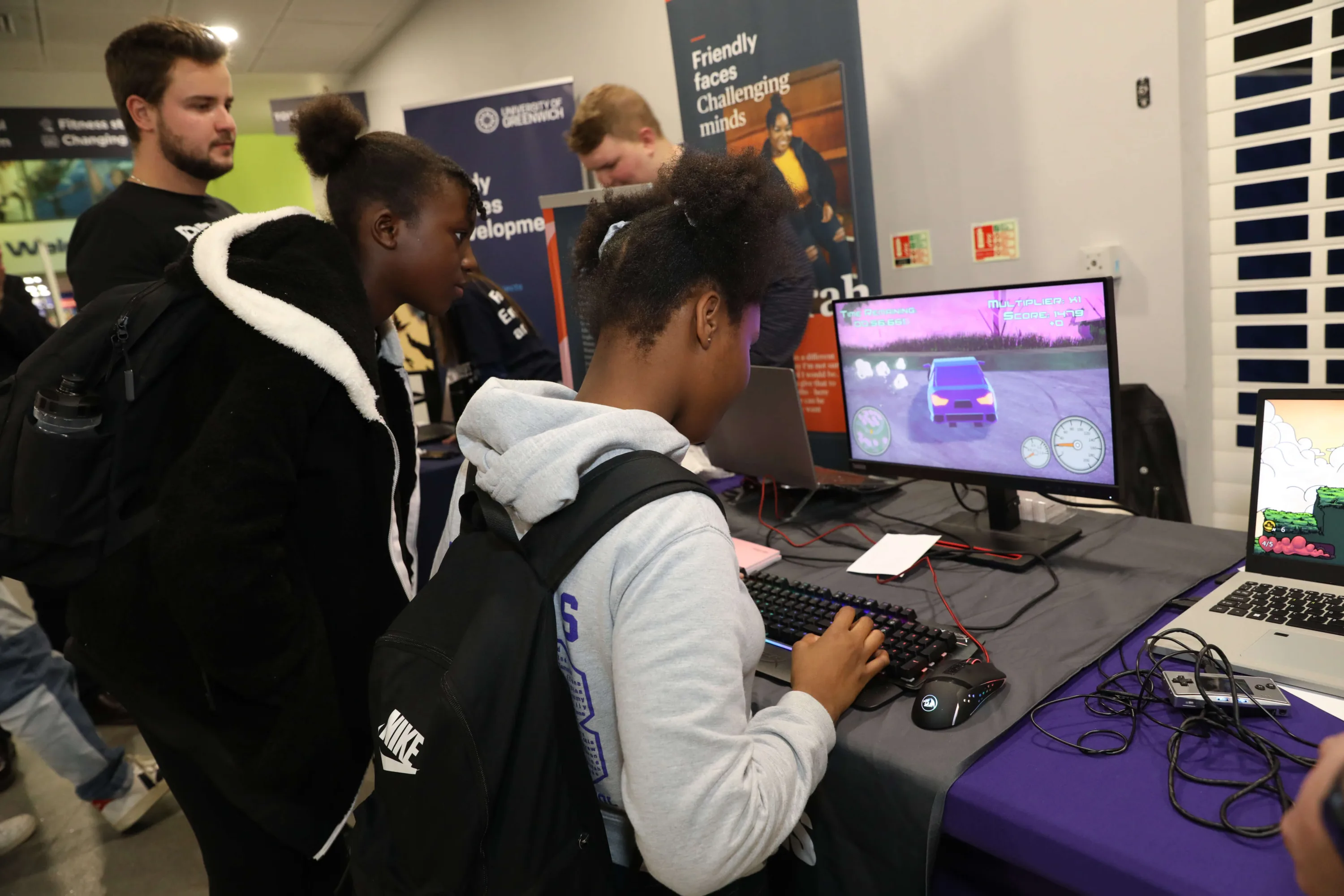 A student interacts directly with a gaming workstation at an event