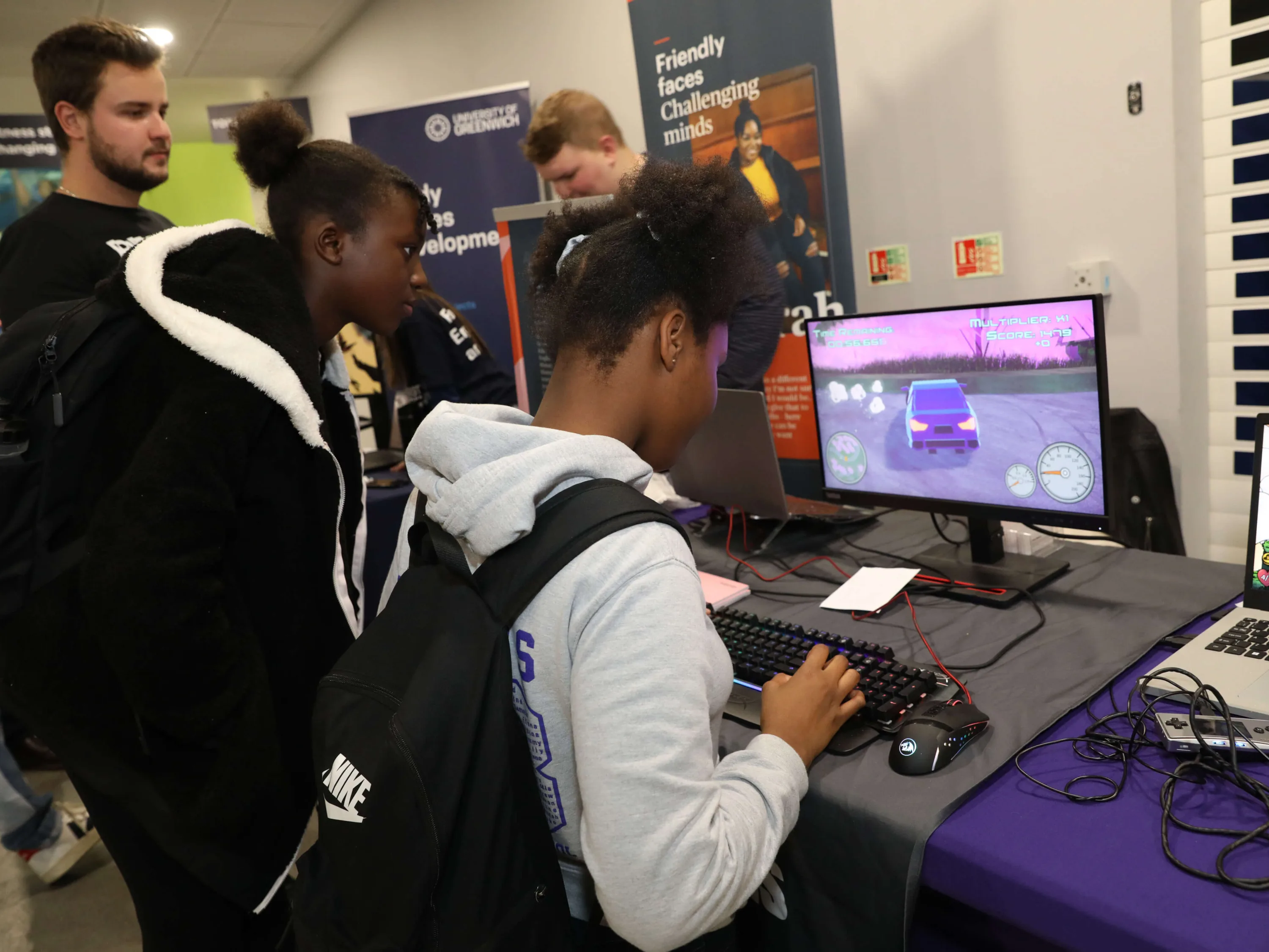 A student interacts directly with a gaming workstation at an event